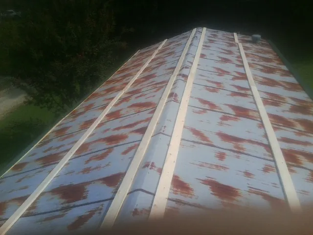 Rusted metal roof panels with new wood purlins before replacement — Storm Damage Roof Repair in Hanover by Roofing Brothers